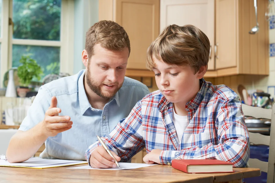 A father helping his son with homework