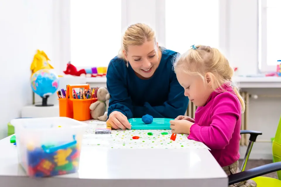 A parent playing with her toddler